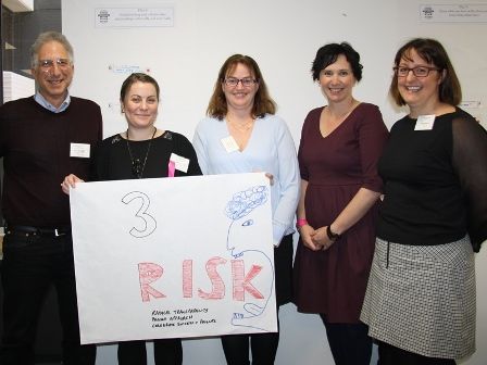 Transforming procurement hack pitch winners The winning group pose for the camera with a poster they made.