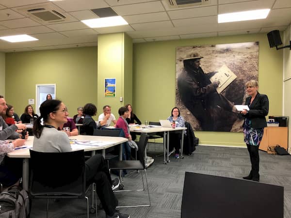 Welcome by GIS manager Christine Bennett. Christine Bennett standing in front of seated guests at the workshop.